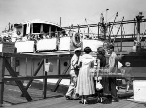 Tourists+taking+tickets+on+Pier+83+before+boarding+the+Sightseer,+circa+1956_